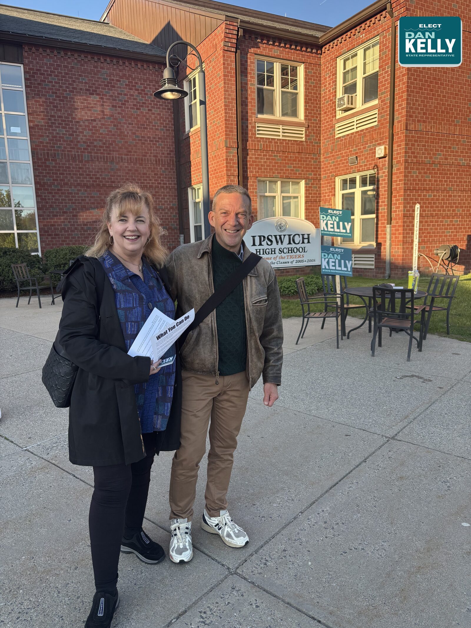 Dan with a supporter outside Ipswich High School, Vote Dan Kelly yard signs visible in the background.